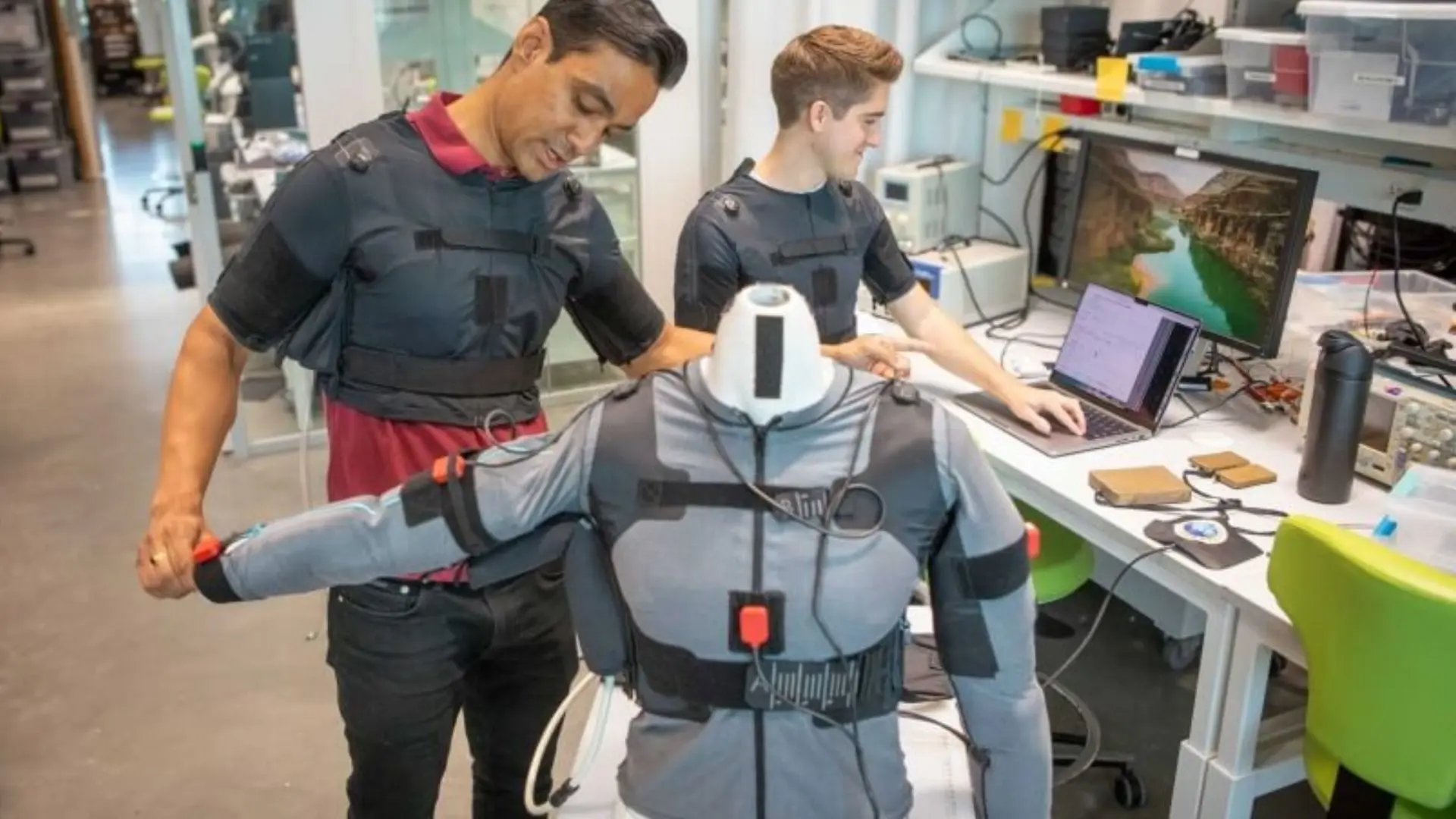 Prabhat Pathak and James Arnold demonstrate the wearable robotic device in the lab. (Harvard)